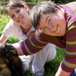 two women petting dog